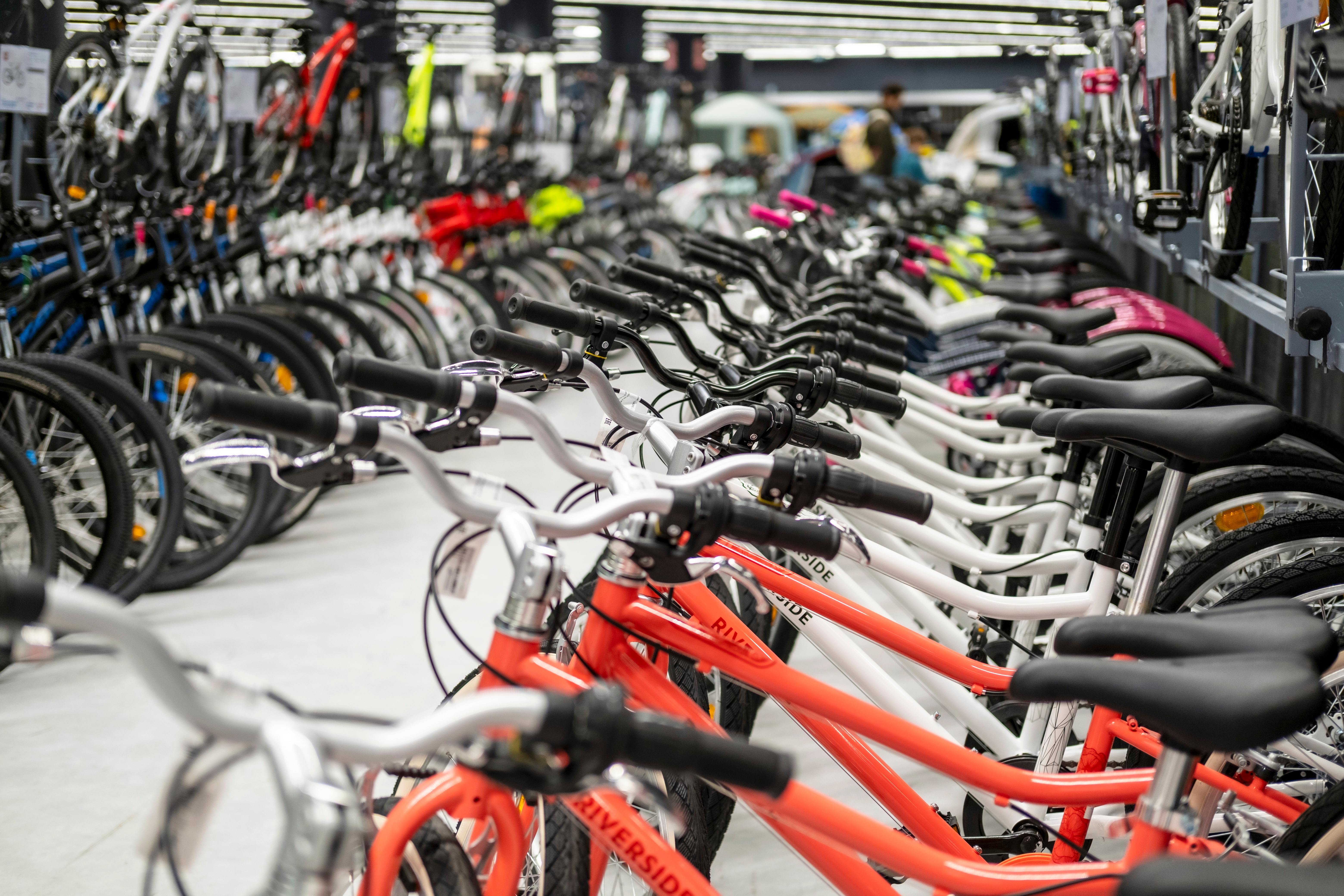 A row of new and colorful bicycles lined up in a bike shop